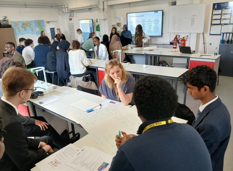 YCC LMS workshop Students and LMS staff around a desk