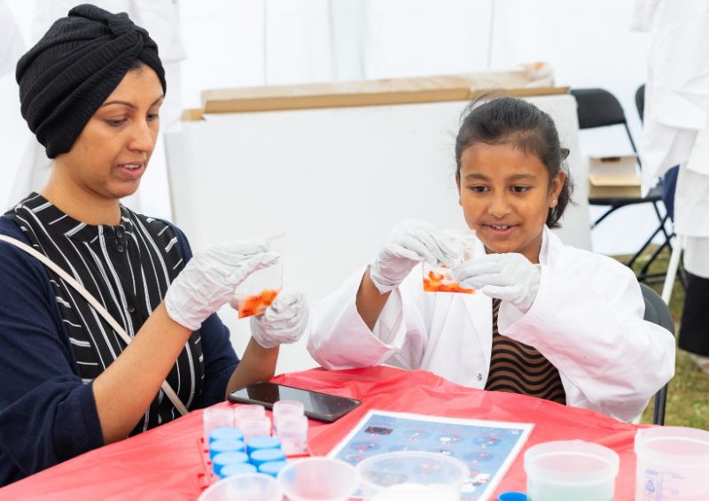 Figure 2: A budding young scientist extracts DNA from a strawberry with one of our volunteers.