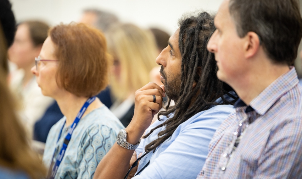 Close up of LMS team members watching presentation