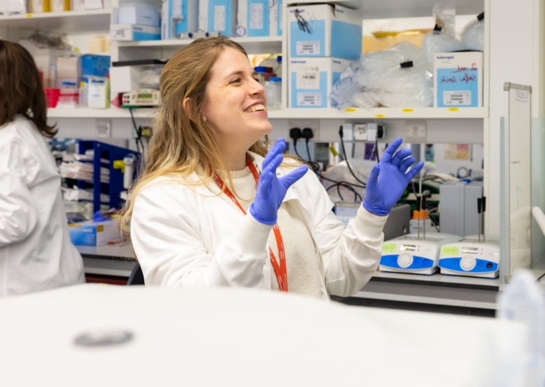 LMS researcher sat at desk with gloves on