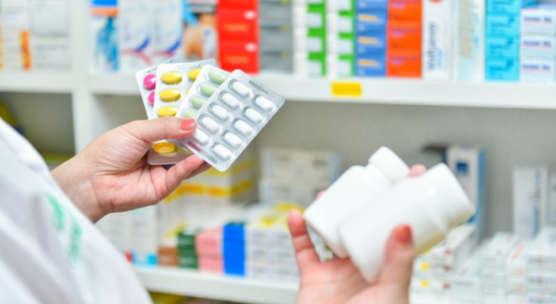 Person Holding pills and pill bottles